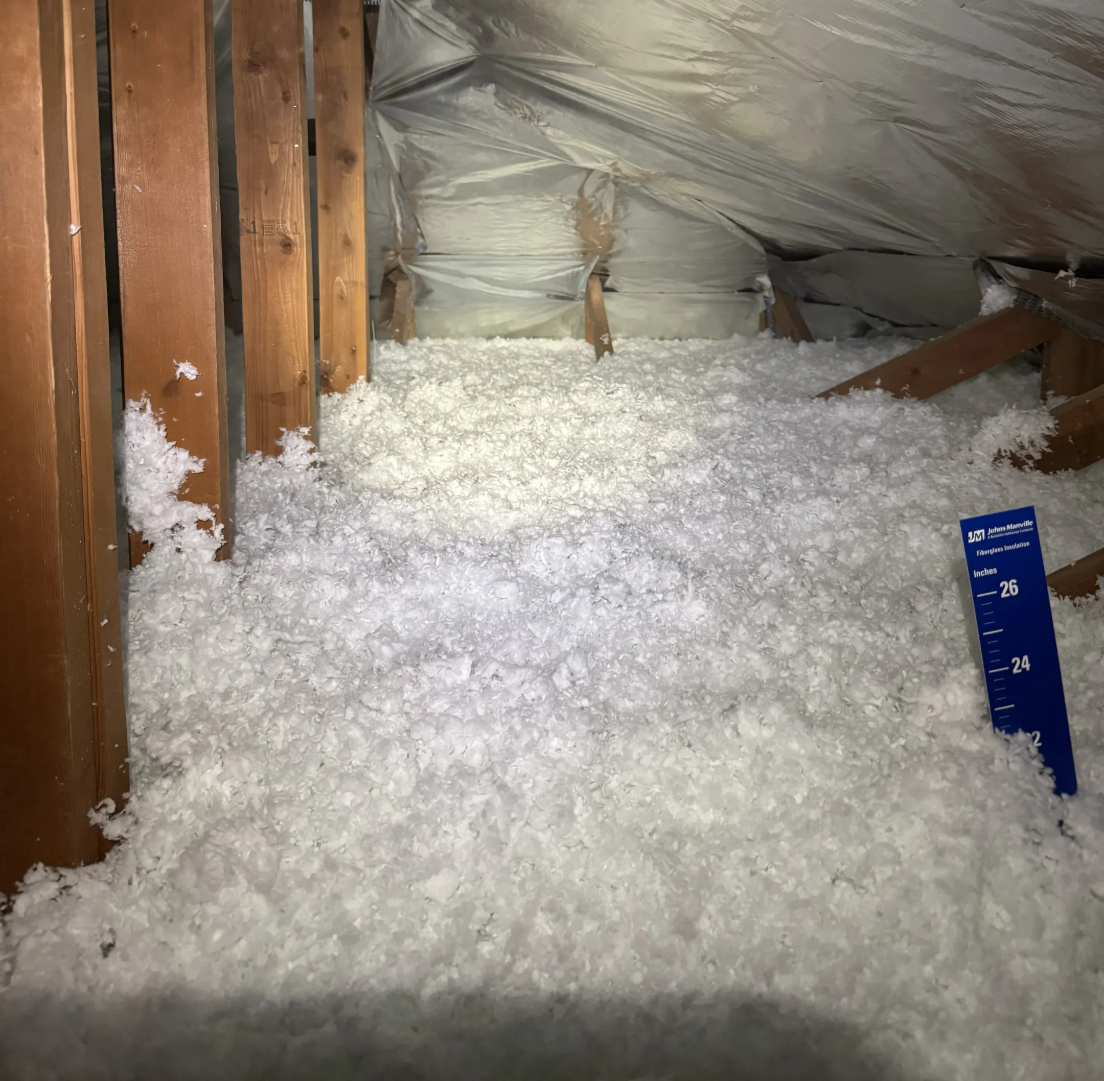 Technician installing attic insulation