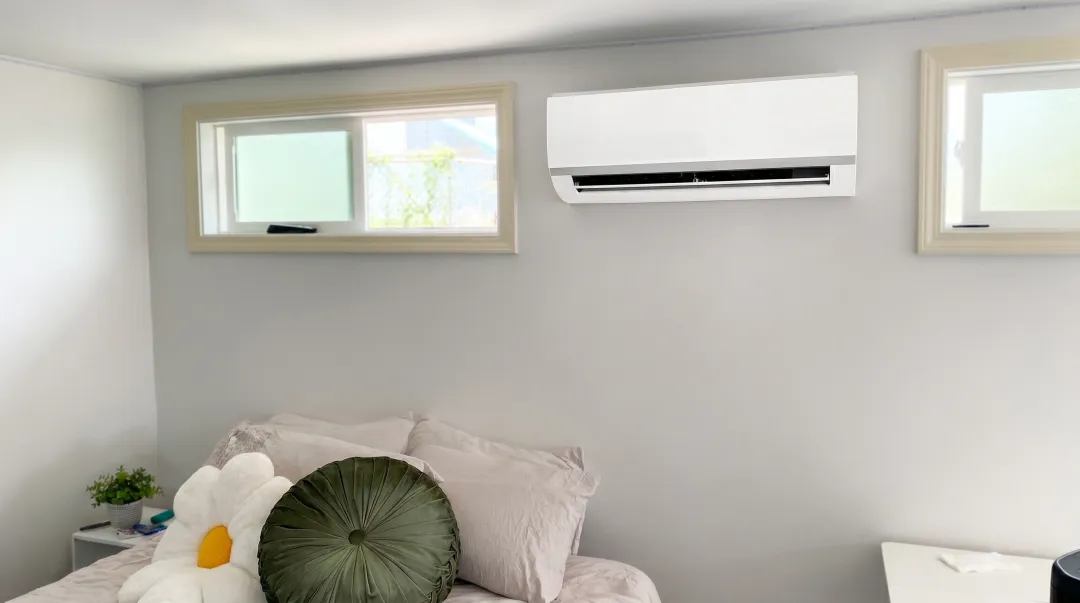 Ductless mini-split HVAC unit installed on bedroom wall interior residential setting