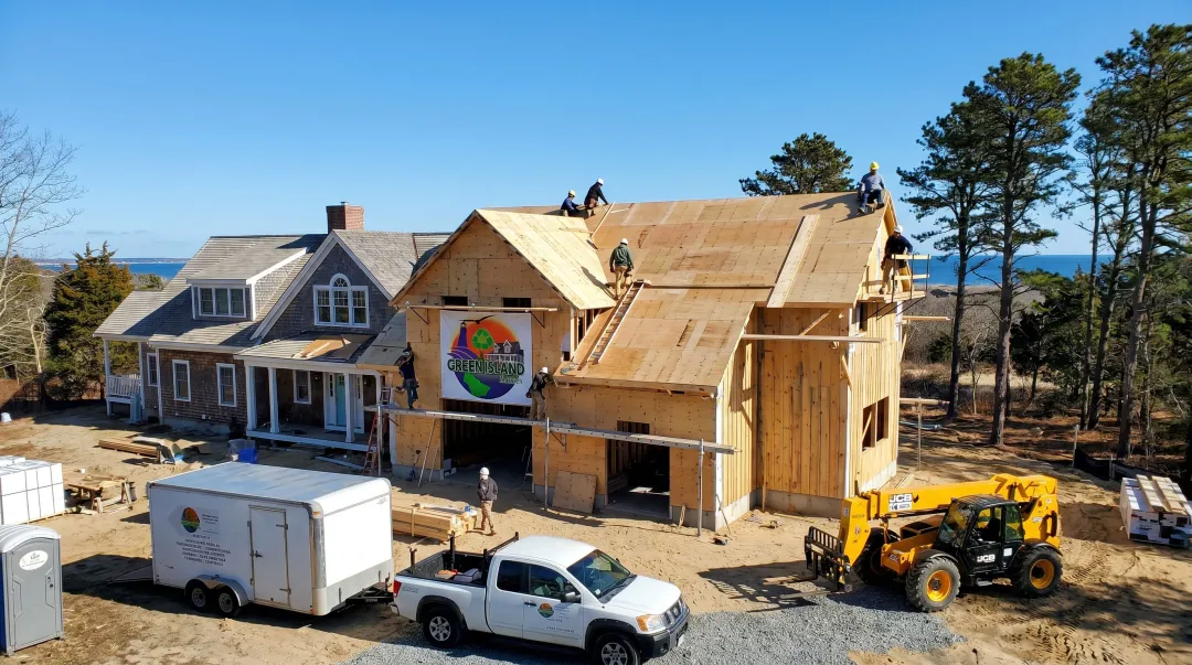 Licensed contractor team completing shed roof home addition on Cape Cod residence