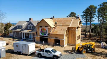 Licensed contractor team completing shed roof home addition on Cape Cod residence