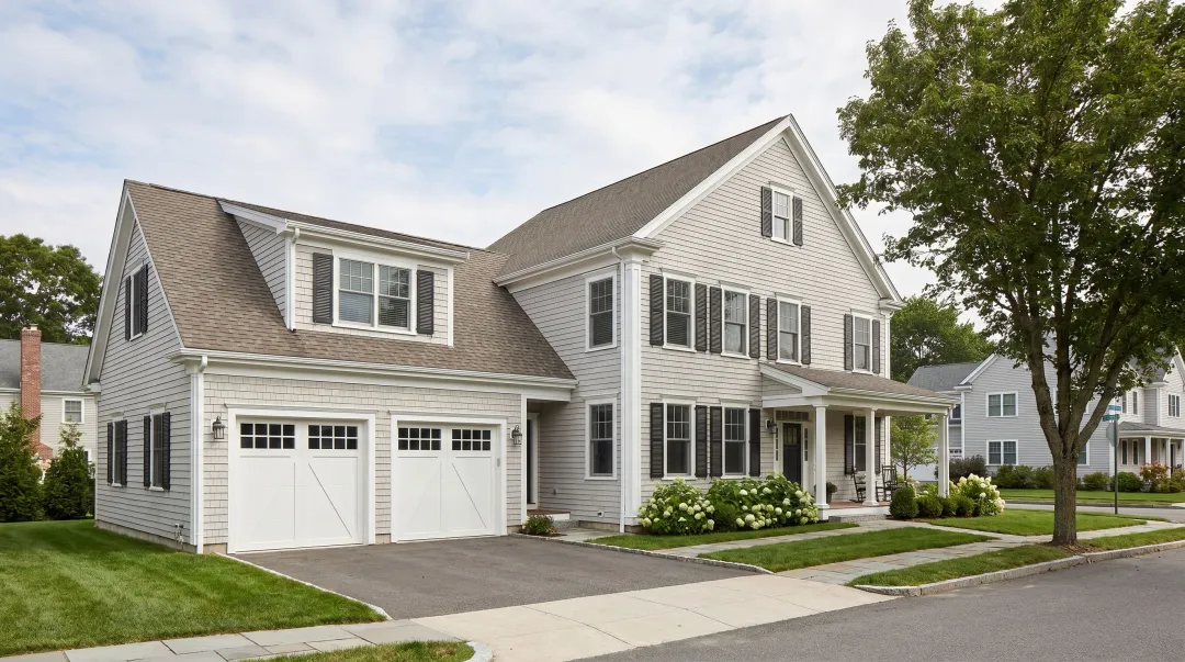 Cape Cod home with attached garage and upper-level living space addition