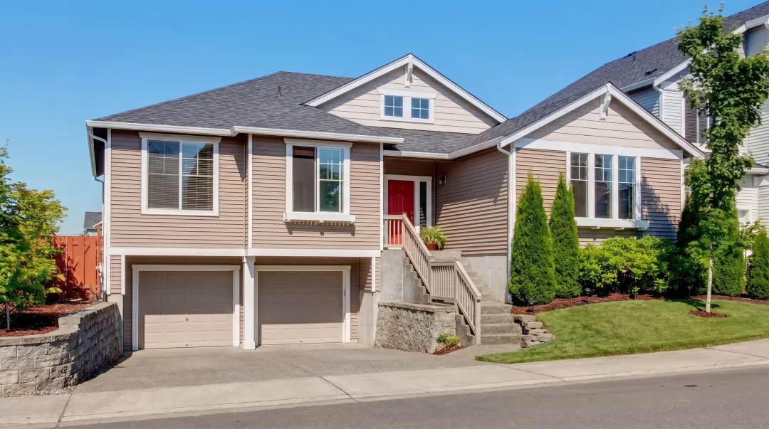 Tuck-under garage integrated into split-level home lower level exterior view