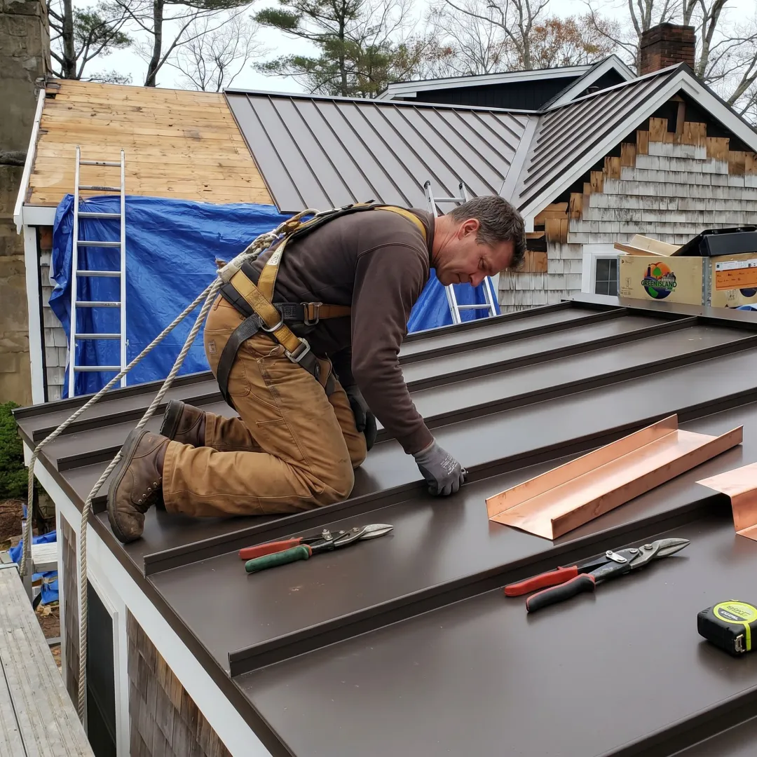Contractor inspecting metal roof panels