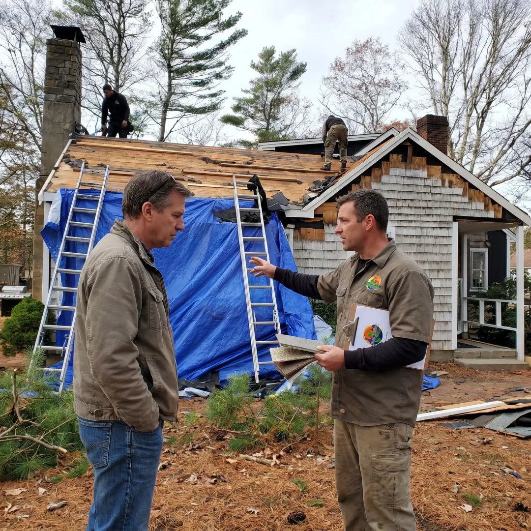 Contractor inspecting roof and siding materials