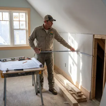 Contractor measuring a home remodeling project
