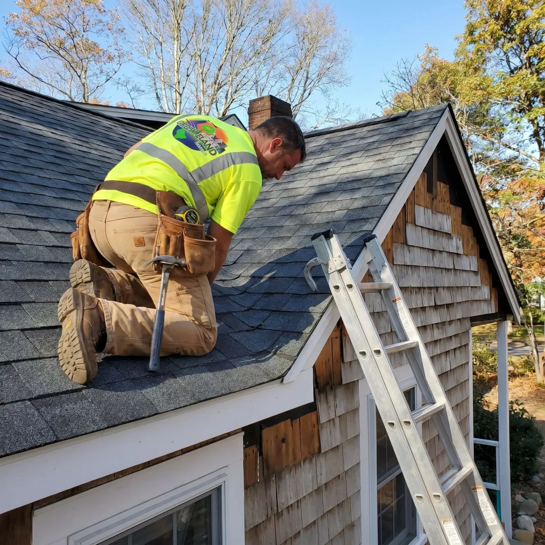 Roofing team reviewing shingle installation