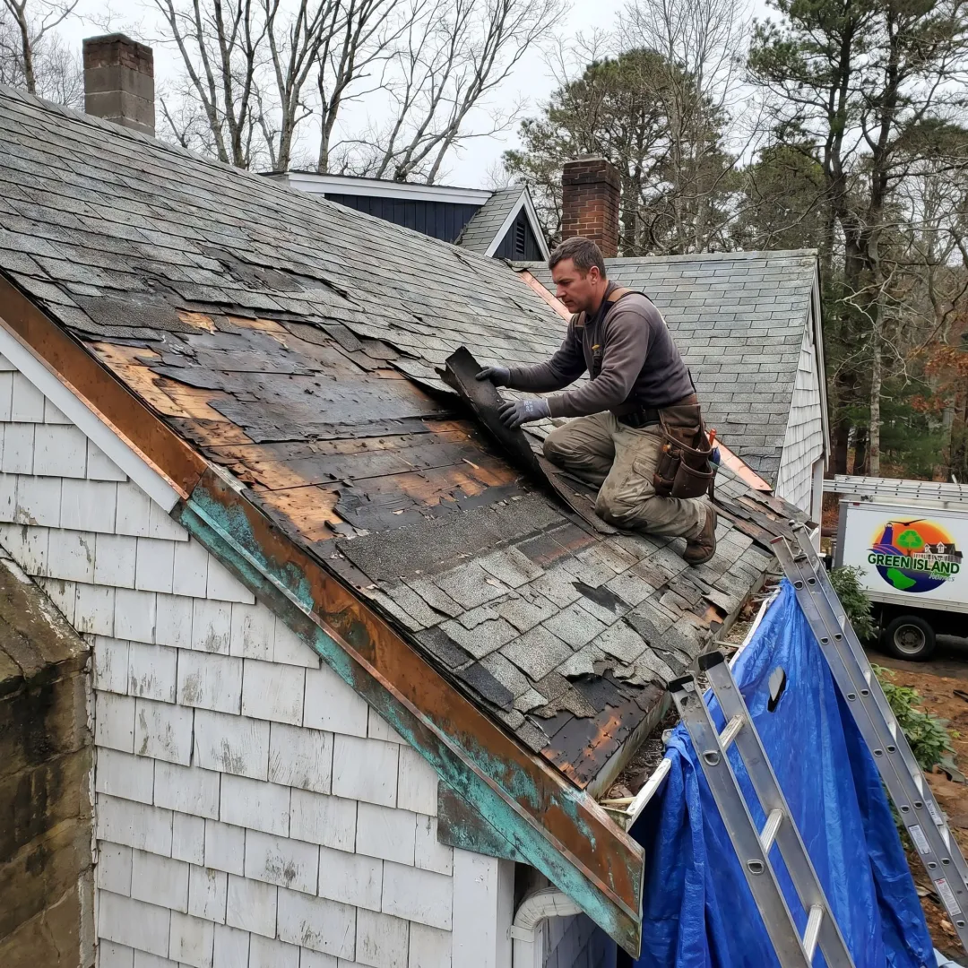 Contractor inspecting roof damage before repair