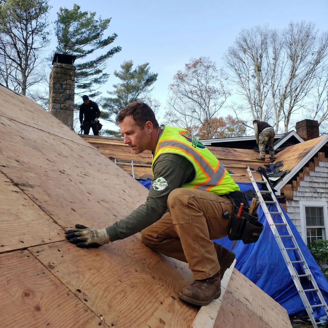 Roof contractor inspecting home roof before coating