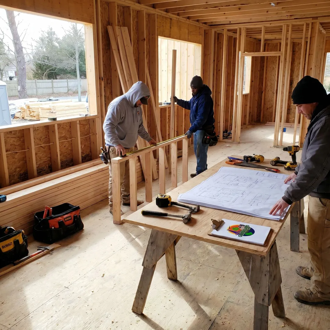 Home remodeling crew coordinating renovation work