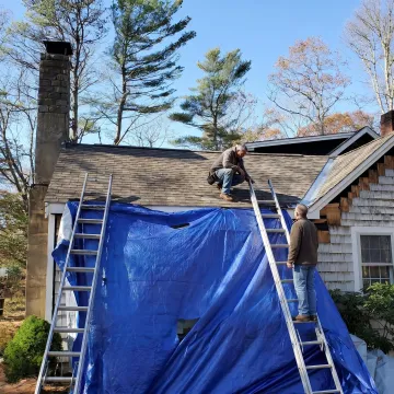 Roofing contractor reviewing roof details with homeowner