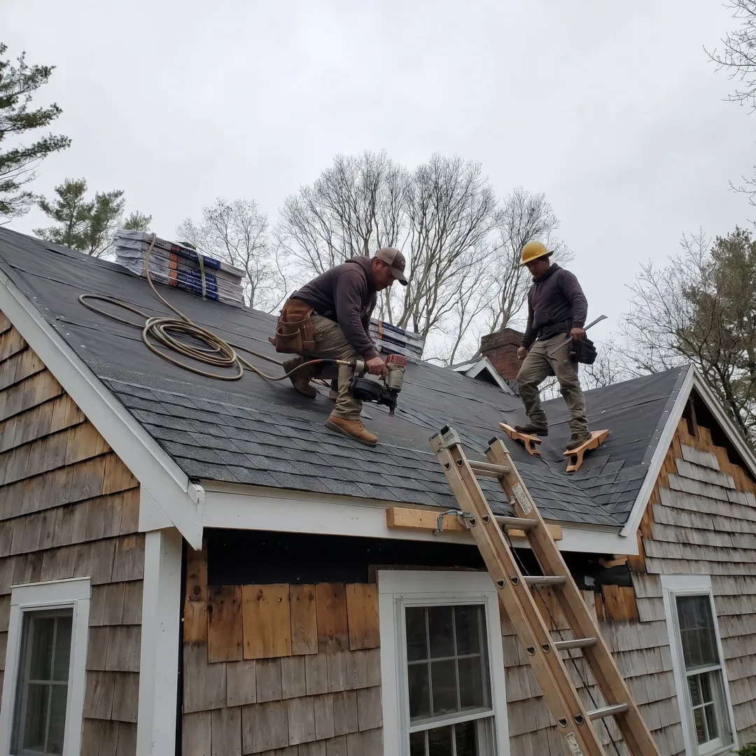 Roofing contractors working on a coastal home