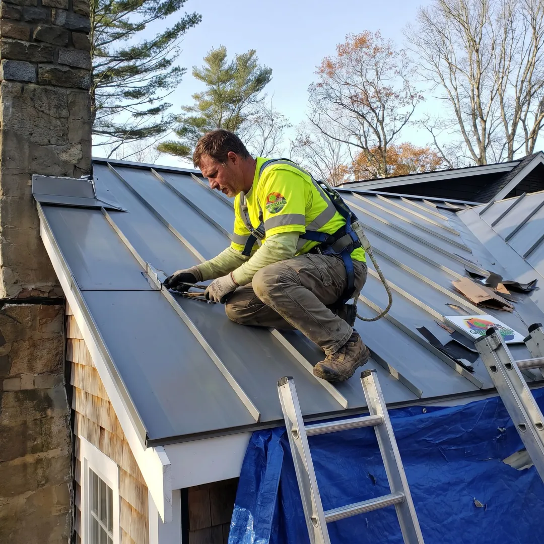 Contractor inspecting a metal roof installation