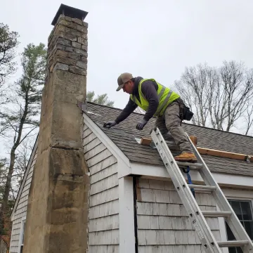 Contractor inspecting a residential roof