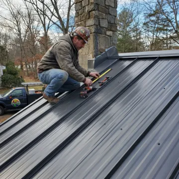Roofing contractor inspecting metal roof panels