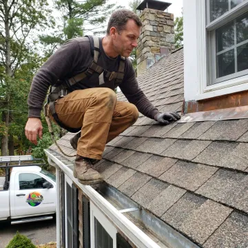 Roofing contractor inspecting a residential roof