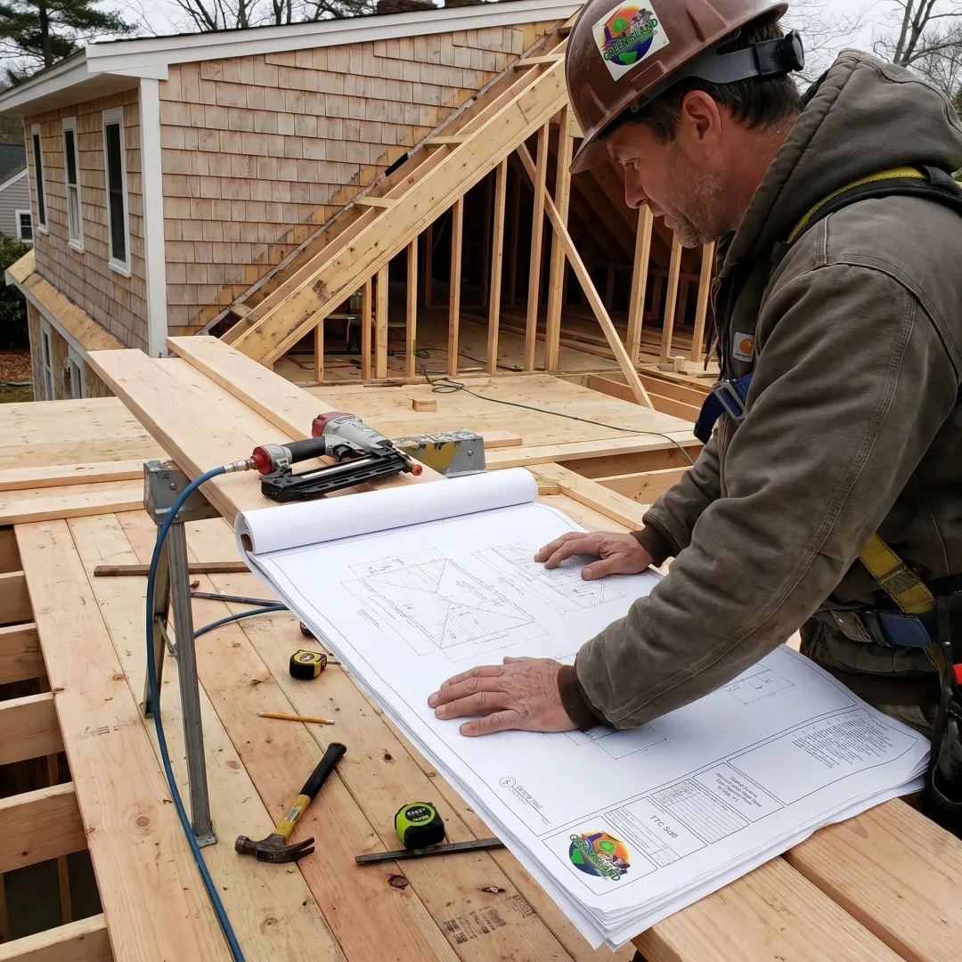 Contractor reviewing roof deck construction plans