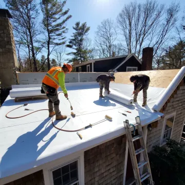 Flat roof installation crew working on a residential roof