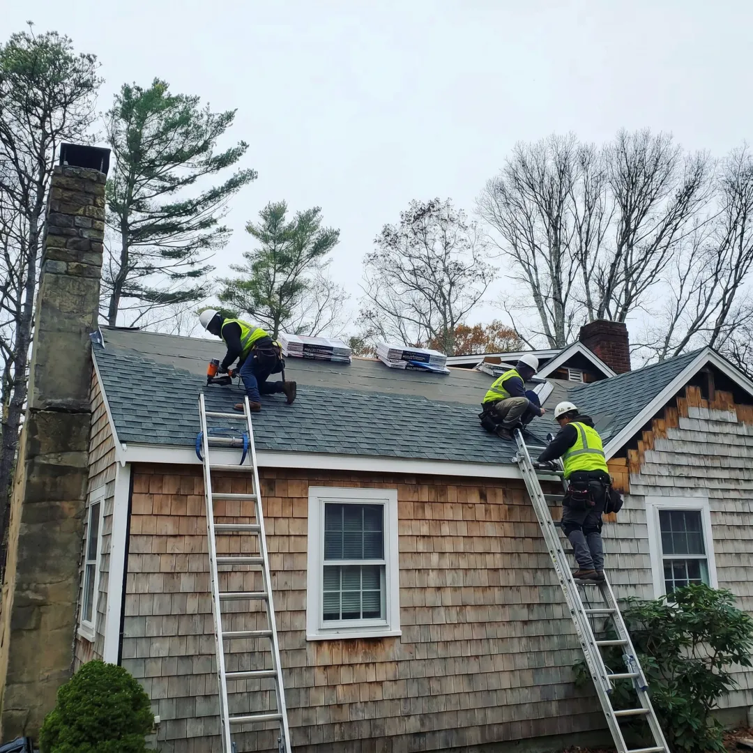 Roofing contractors working on a Cape Cod home