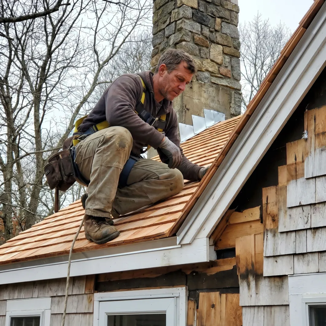 Contractor inspecting cedar shake roofing