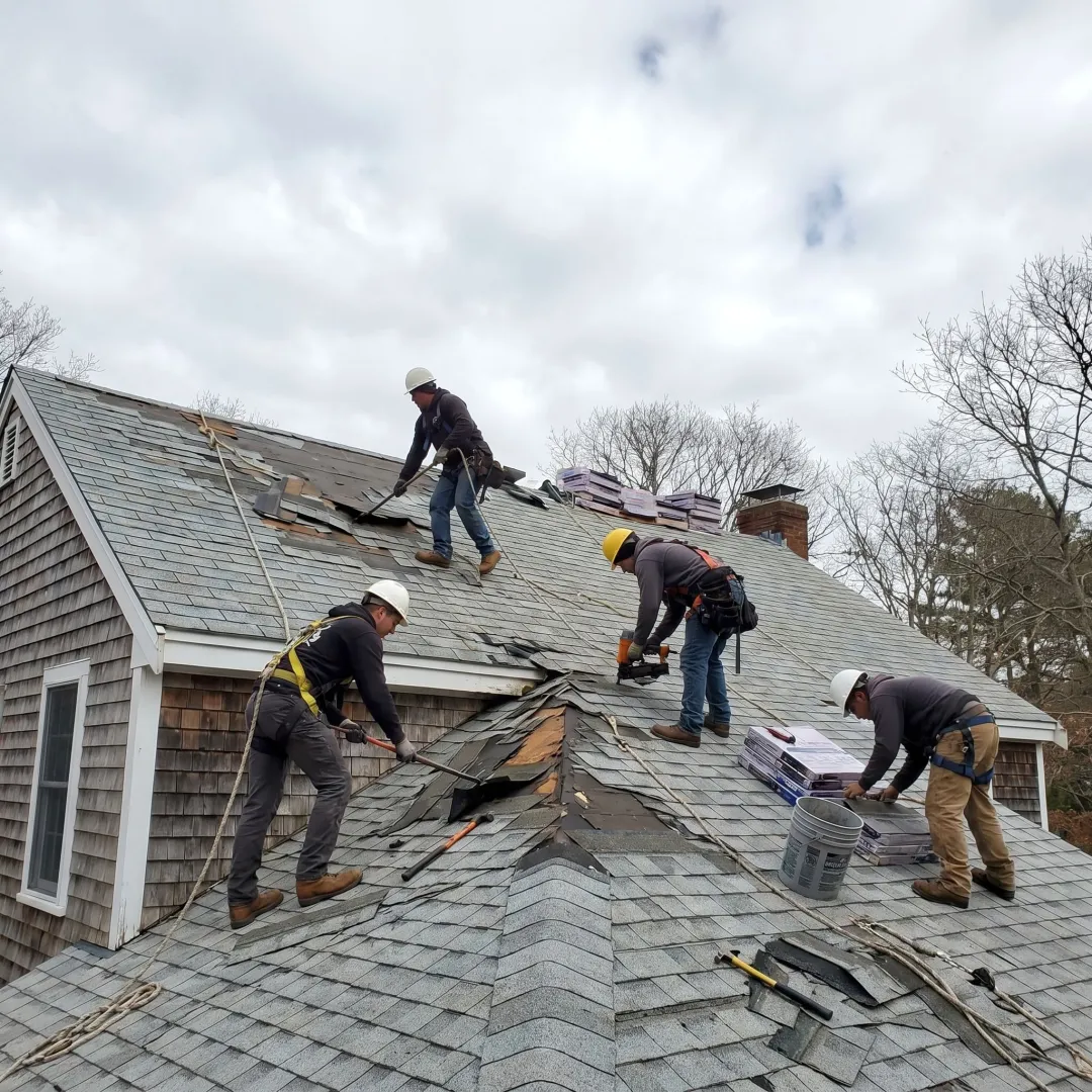 Roof repair crew working on storm damaged home
