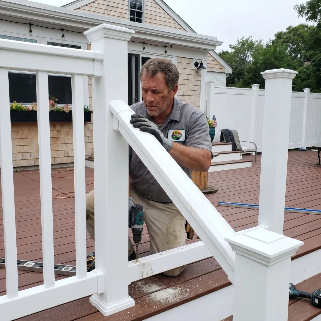 Contractor installing deck railing on a coastal home
