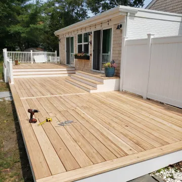 Resurfaced residential deck with clean boards and railings