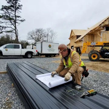 Contractor reviewing metal roof plans