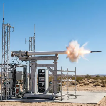 High-velocity single-shot launcher system firing projectile at test facility