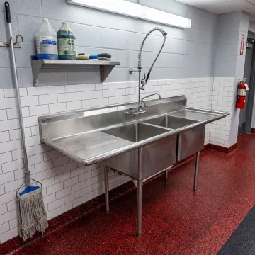 Stainless steel washdown sink in a fire station utility area
