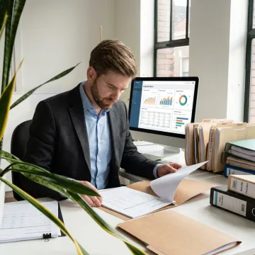 Consultant reviewing organized bookkeeping reports