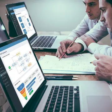 Team reviewing custom ERP dashboards and integrations