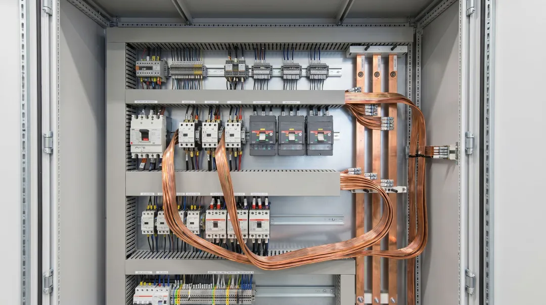 Flexible laminated busbar installed inside industrial power distribution panel enclosure