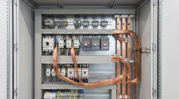 Flexible laminated busbar installed inside industrial power distribution panel enclosure