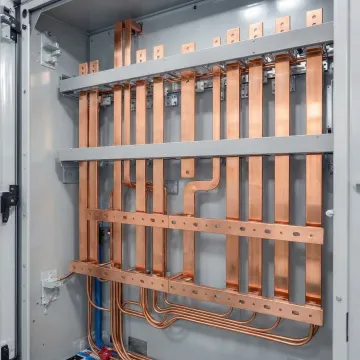 Precision-cut copper busbars stacked for industrial power distribution installation