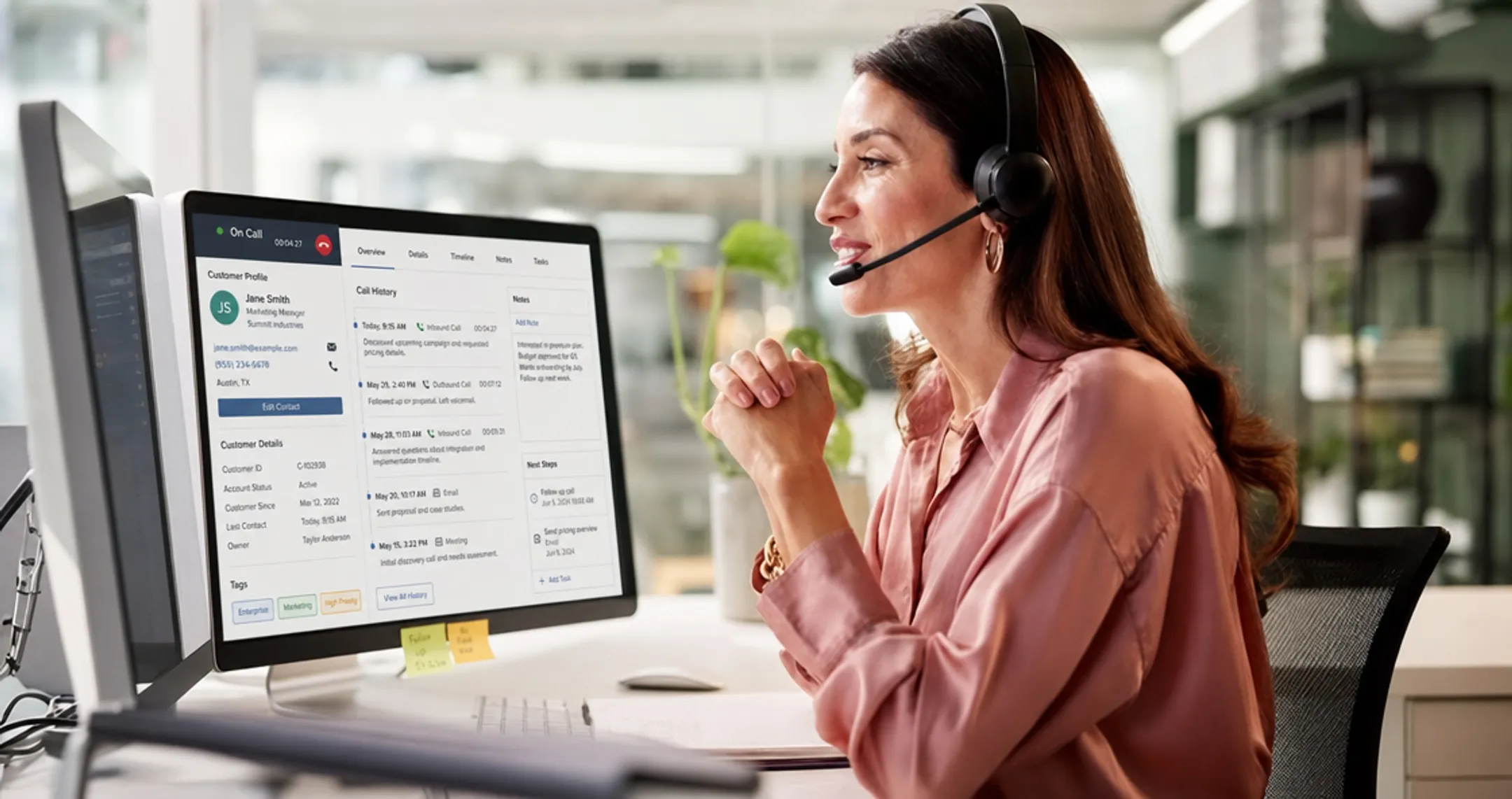 Customer service agent using headset while viewing CRM dashboard screen