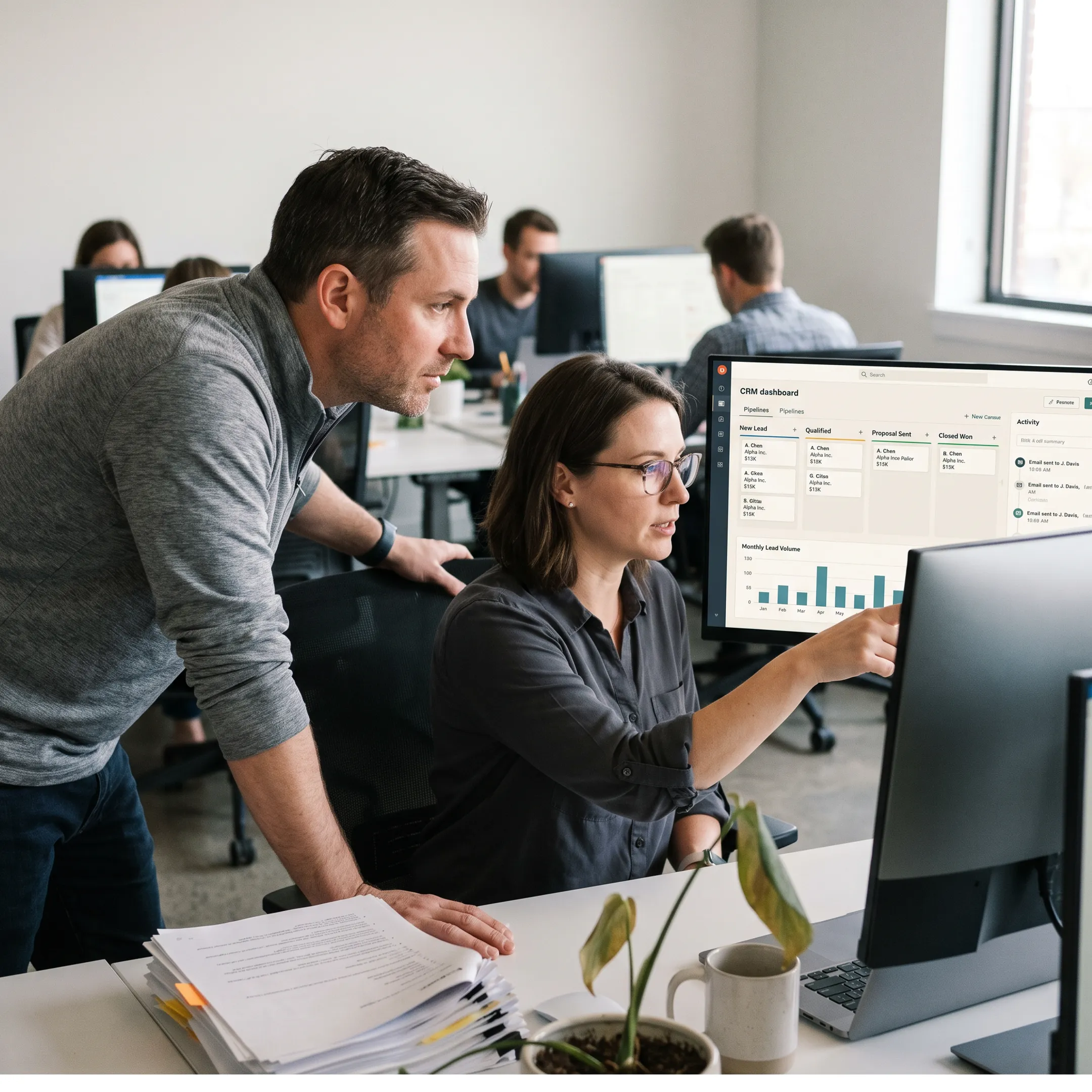 Laboratory team reviewing CRM data on a desktop dashboard