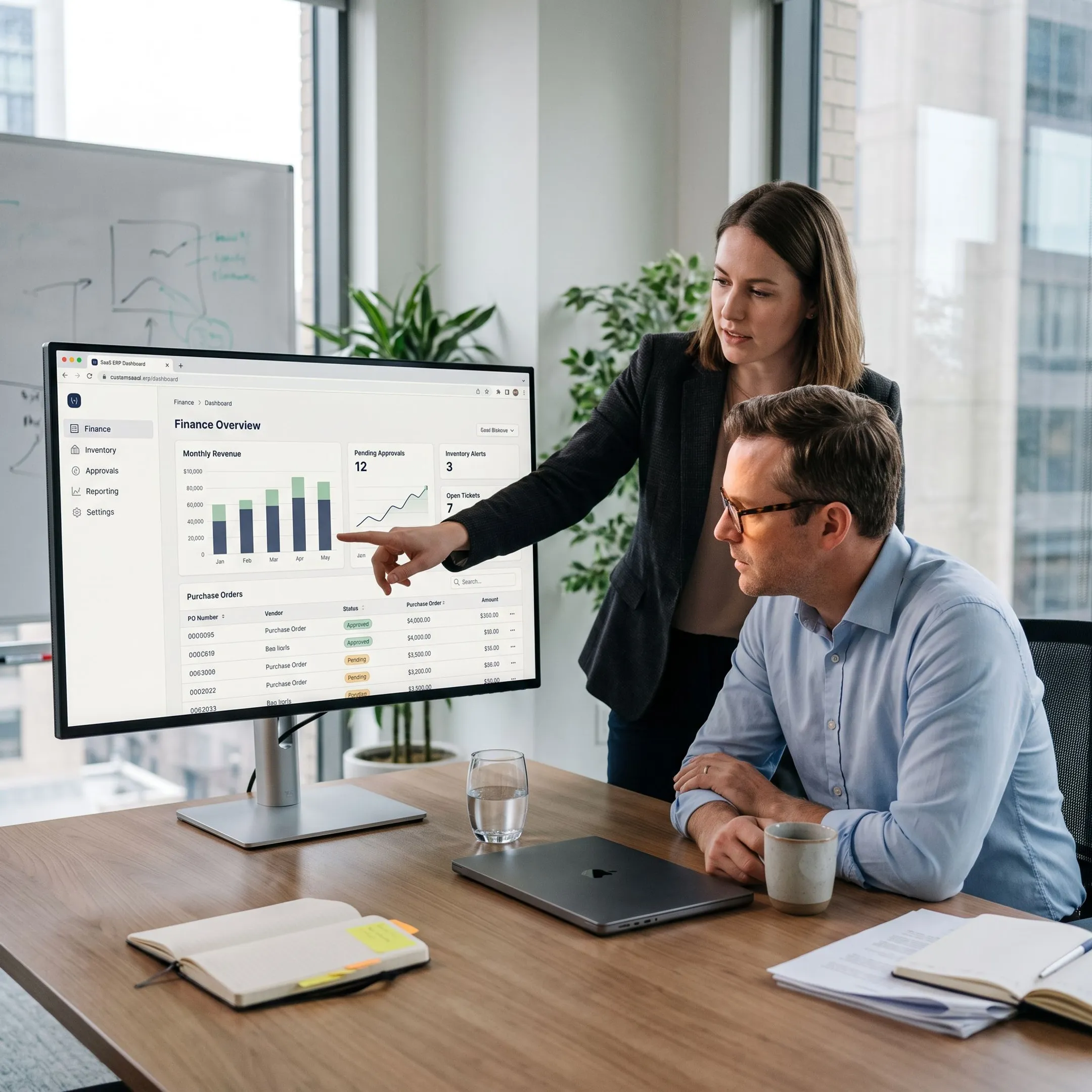 Team reviewing a custom ERP dashboard on a laptop