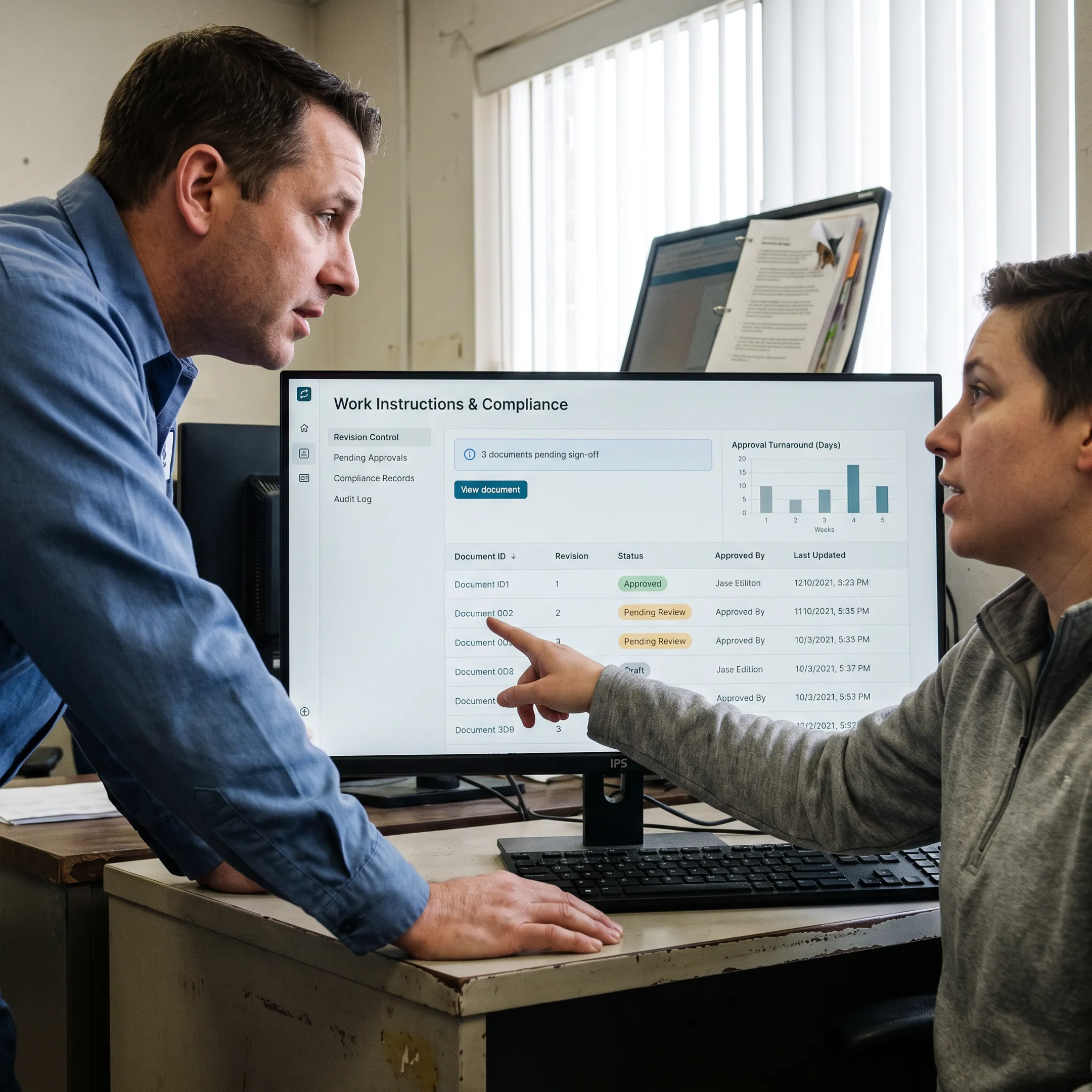 Manufacturing team reviewing controlled documents on software dashboard