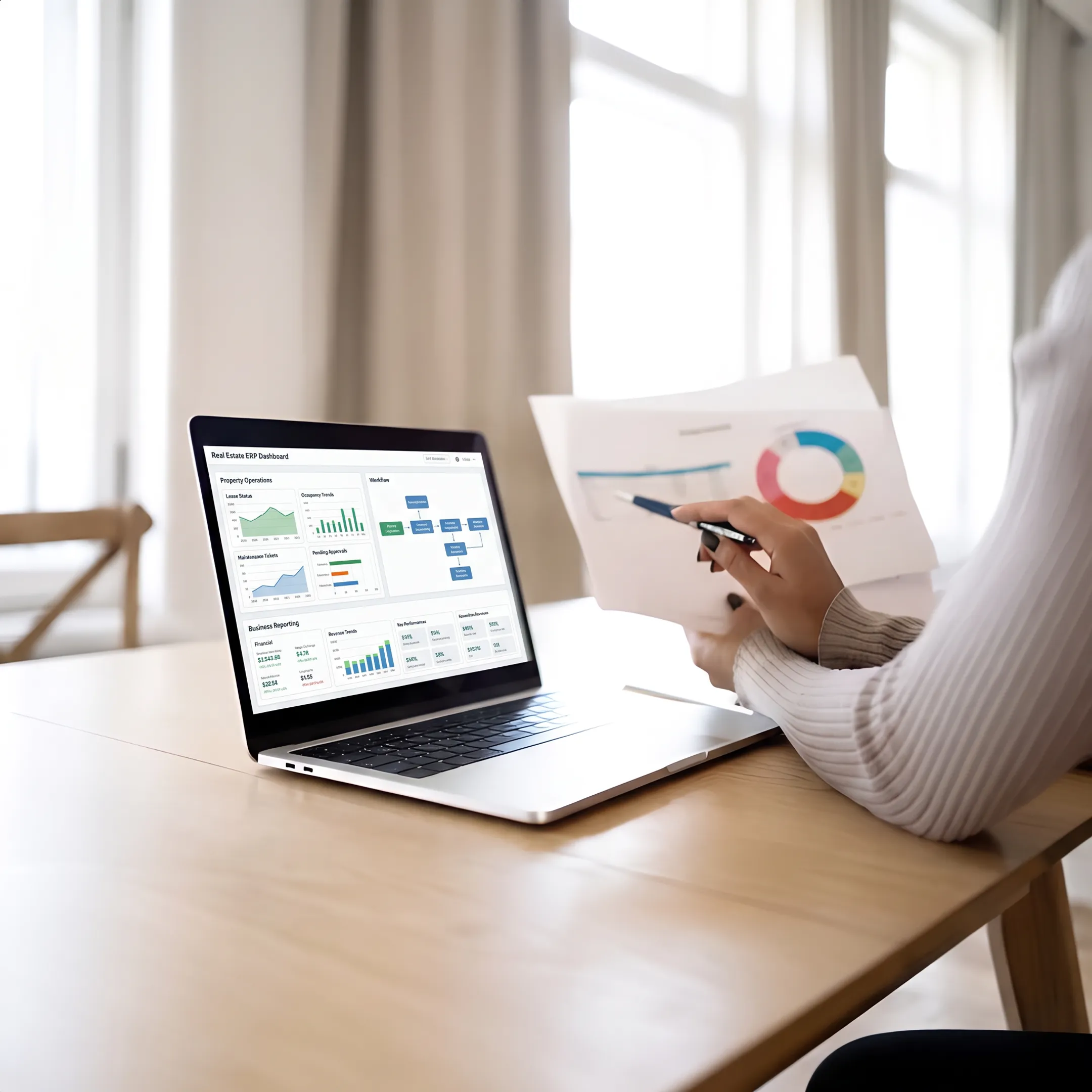 Real estate ERP dashboard displayed on a laptop in a modern office