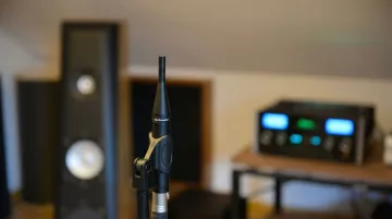 Calibrated measurement microphone positioned in treated room during acoustic testing session