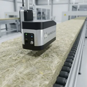 M-Ray sensor head scanning mineral wool insulation material on an industrial conveyor