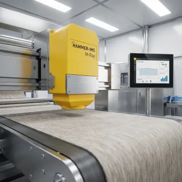 M-Ray sensor head performing contactless thickness measurement on production line