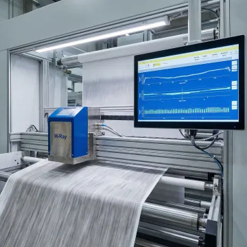 M-Ray thickness measurement sensor monitoring calendered sheet material in production