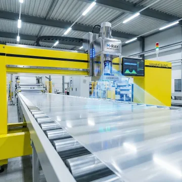 M-Ray sensor head measuring plastic sheet thickness in production environment