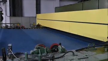 Close-up of M-Ray sensor head measuring material thickness with digital display showing real-time data