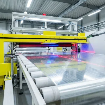 Inline surface inspection system scanning glass fiber material on a production line