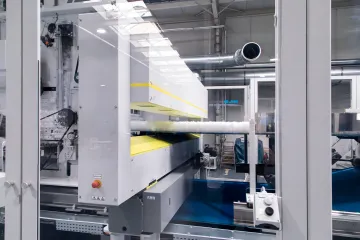 Multi-sensor inspection system scanning flat material surface on an industrial production line