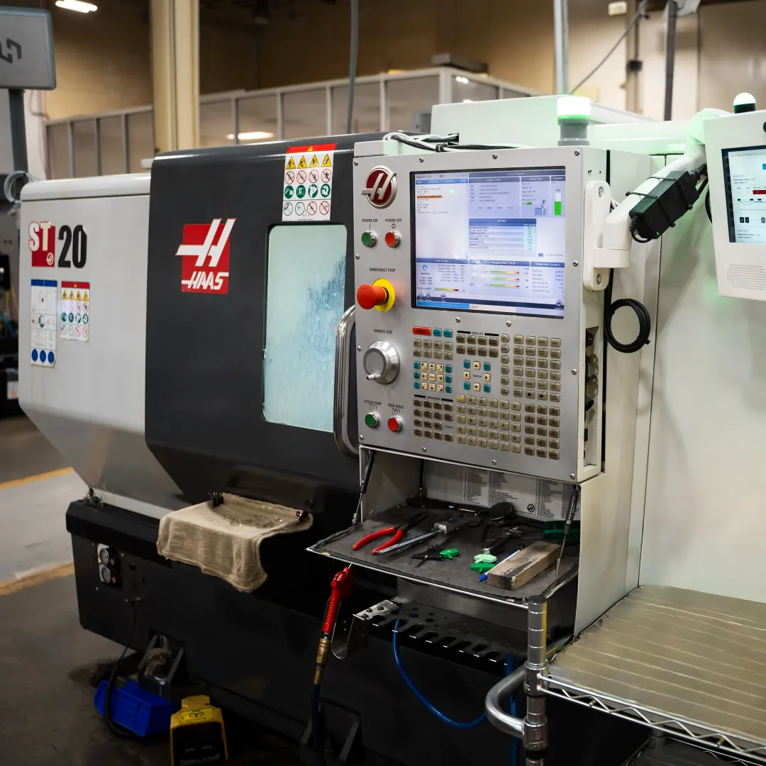 Operator reviewing downtime data at a CNC machine