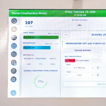 Operator using RFID time tracking at a CNC machine