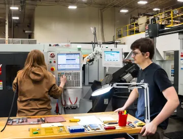 Operator using Harmoni interface at a CNC workcenter